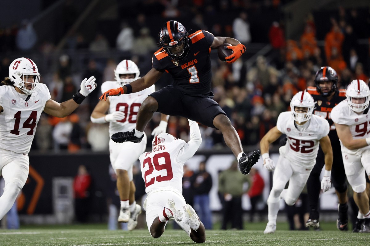 Nov 11, 2023; Corvallis, Oregon, USA; Oregon State Beavers running back Deshaun Fenwick (1) jumps over Stanford Cardinal corner back Terian Williams (29) during the second half at Reser Stadium. Mandatory Credit: Soobum Im-USA TODAY Sports  